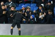 Hazard handing over his shirt to a young fan